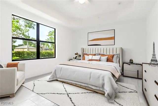 a bedroom with a bed and a large window