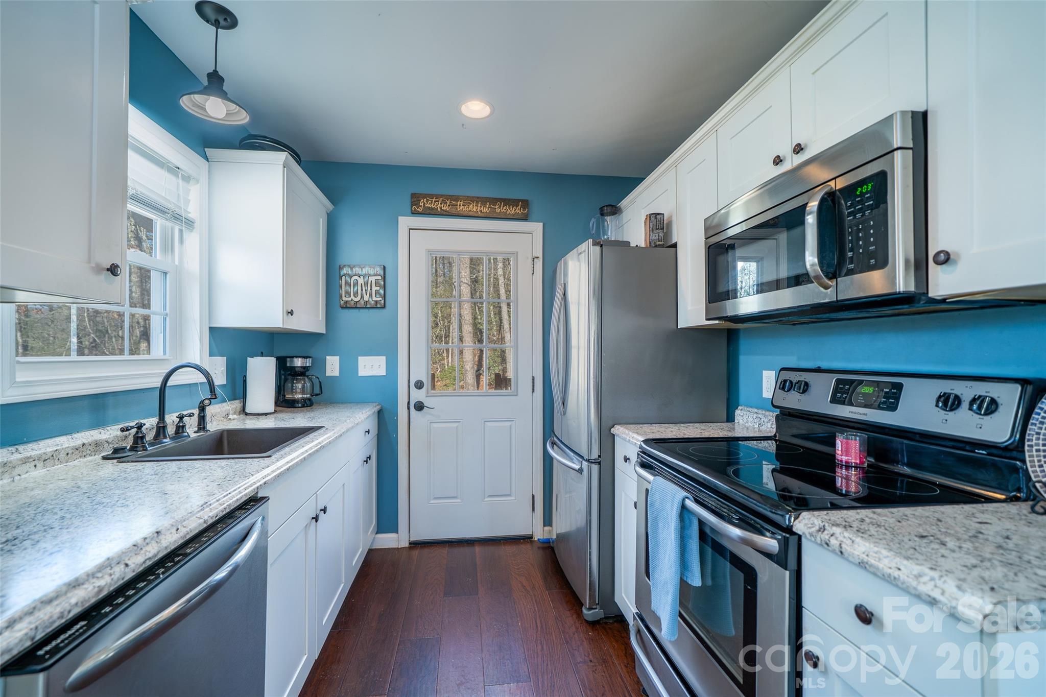 412 Masters View Drive Etowah, NC 28729 - Photo 11 of 30 a kitchen with stainless steel appliances granite countertop a sink stove and refrigerator