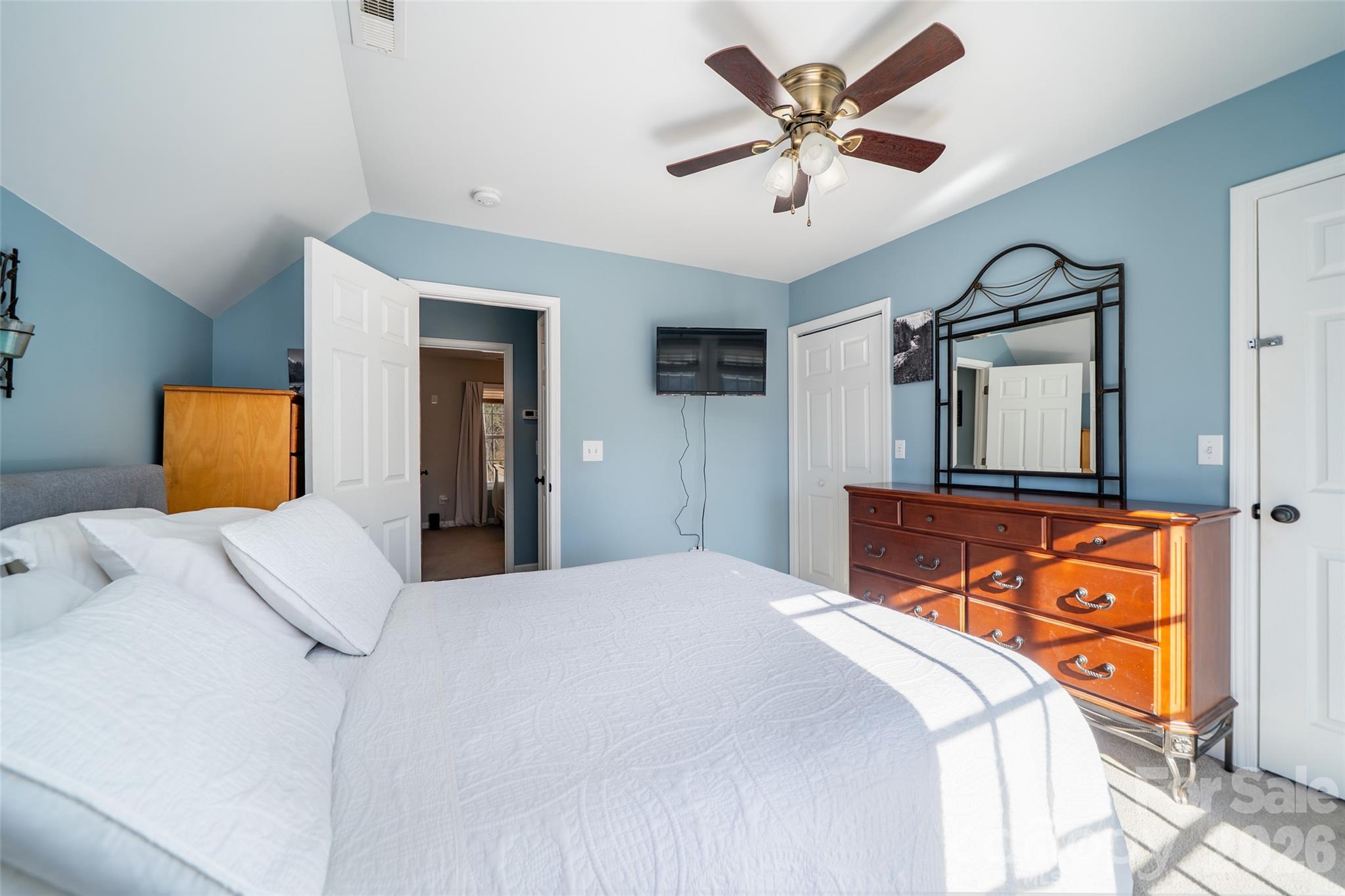 412 Masters View Drive Etowah, NC 28729 - Photo 15 of 30 a bedroom with a bed and a chandelier