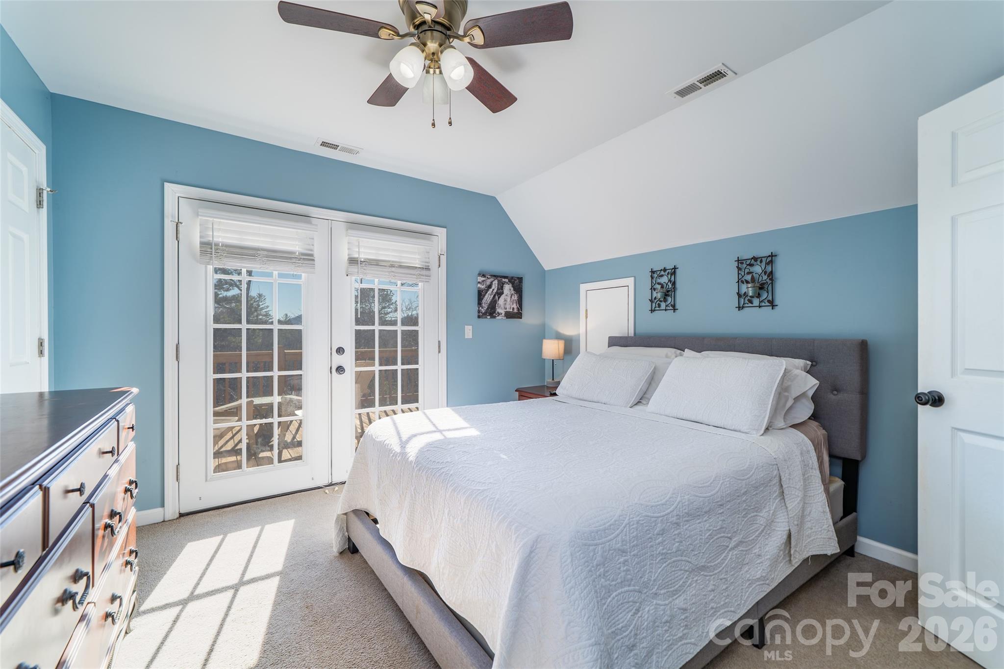 412 Masters View Drive Etowah, NC 28729 - Photo 16 of 30 a bedroom with a large bed and a chandelier