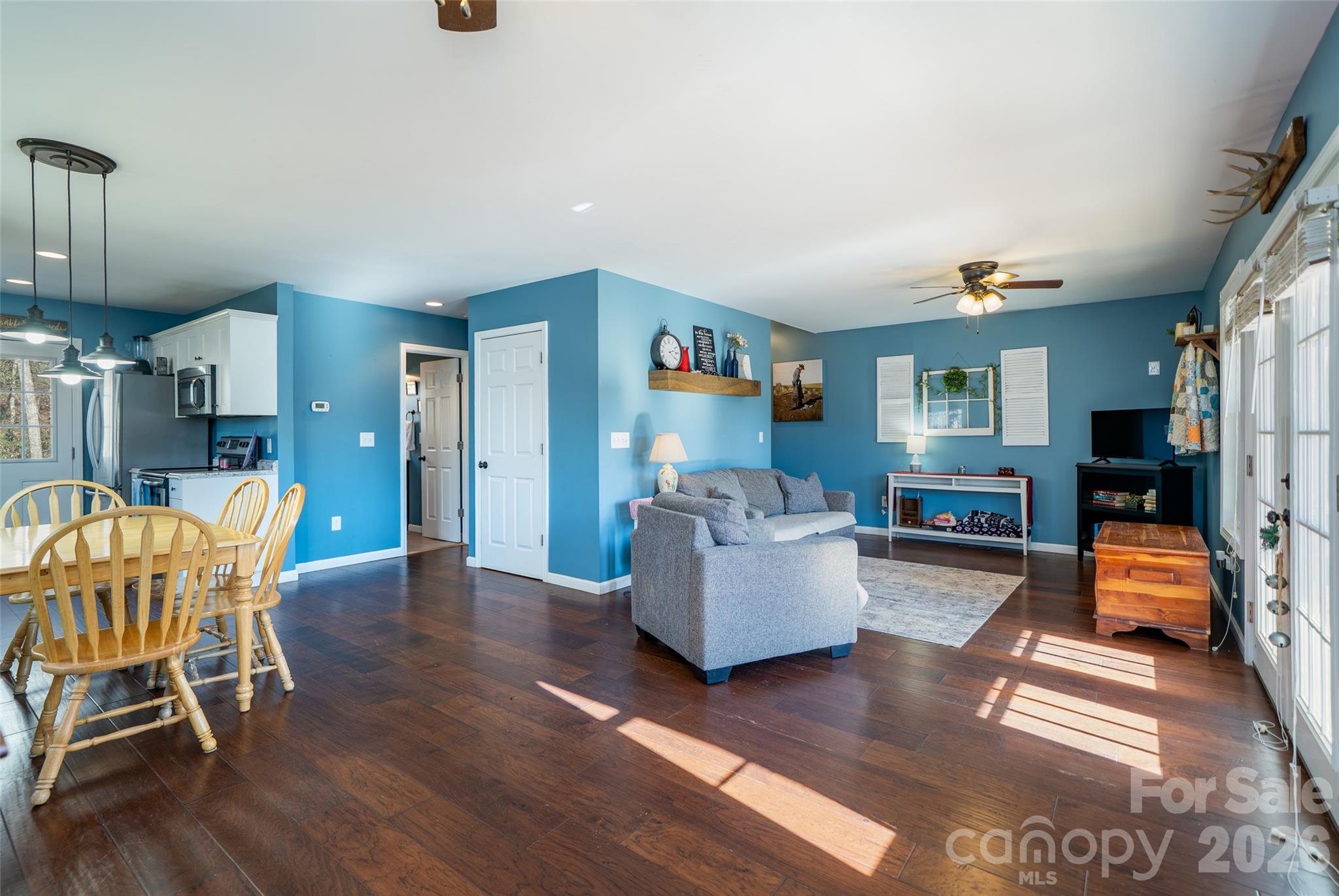 412 Masters View Drive Etowah, NC 28729 - Photo 8 of 30 a living room with furniture and a dining table with wooden floor