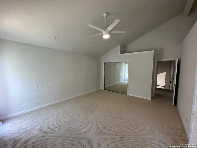 a dining room with furniture a chandelier and wooden floor