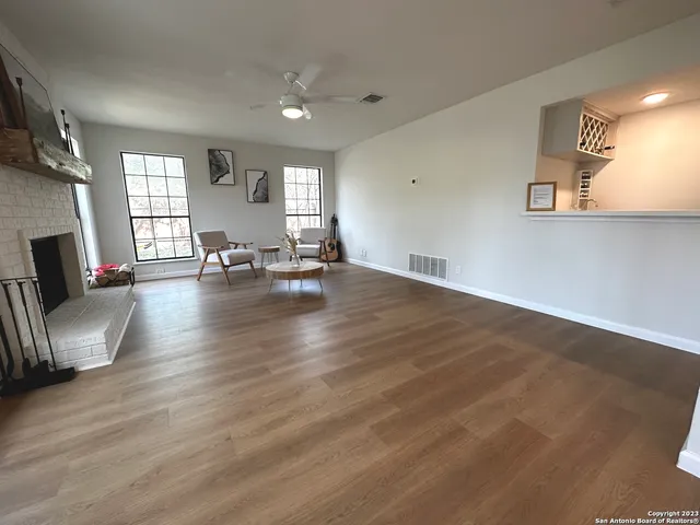 a bedroom with a bed ceiling fan and a window