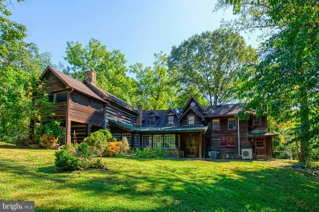 a yellow house in middle of the green field