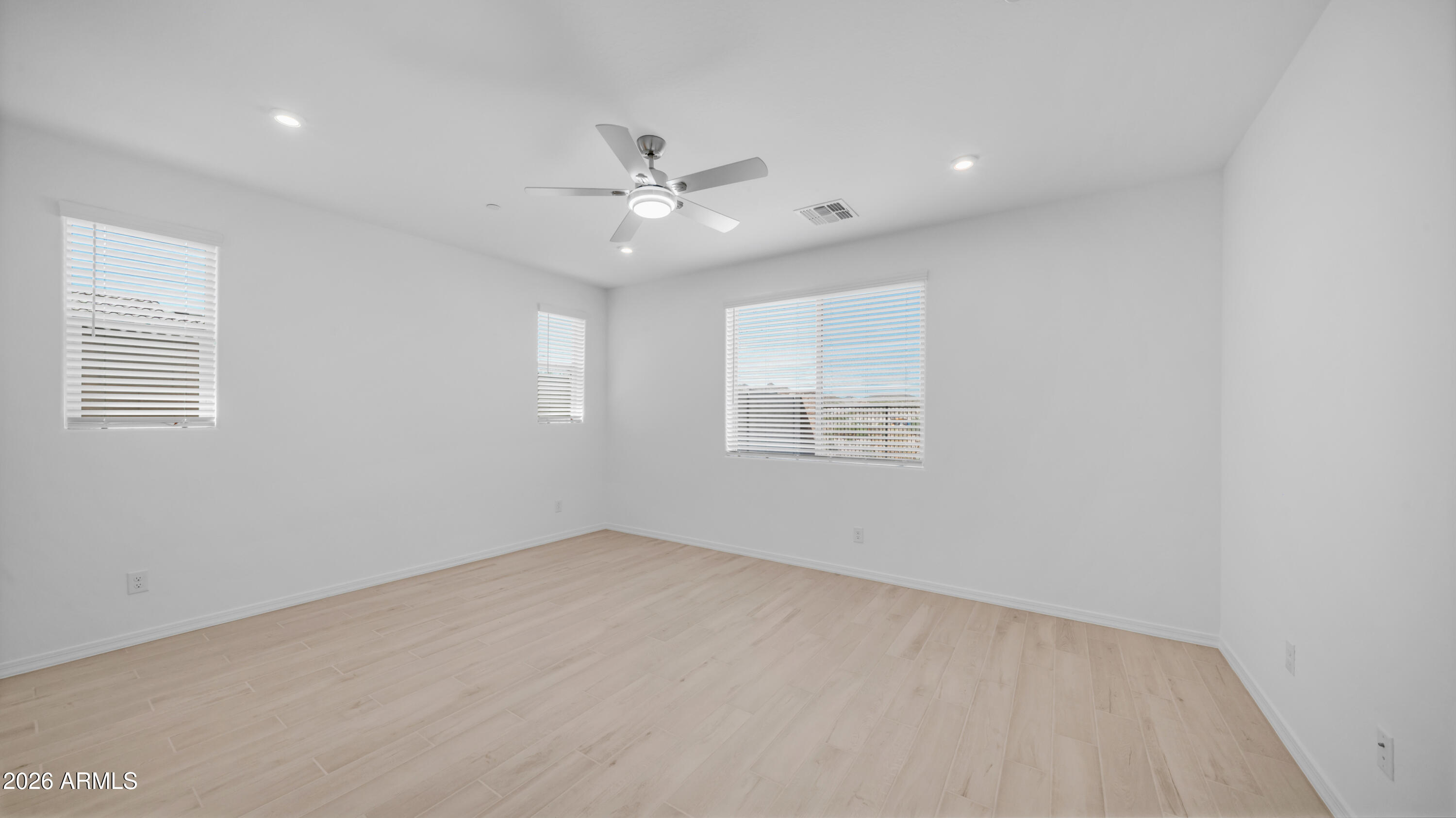 13362 West Eagle Feather Road Peoria, AZ 85383 - Photo 12 of 44 an empty room with a window and ceiling fan