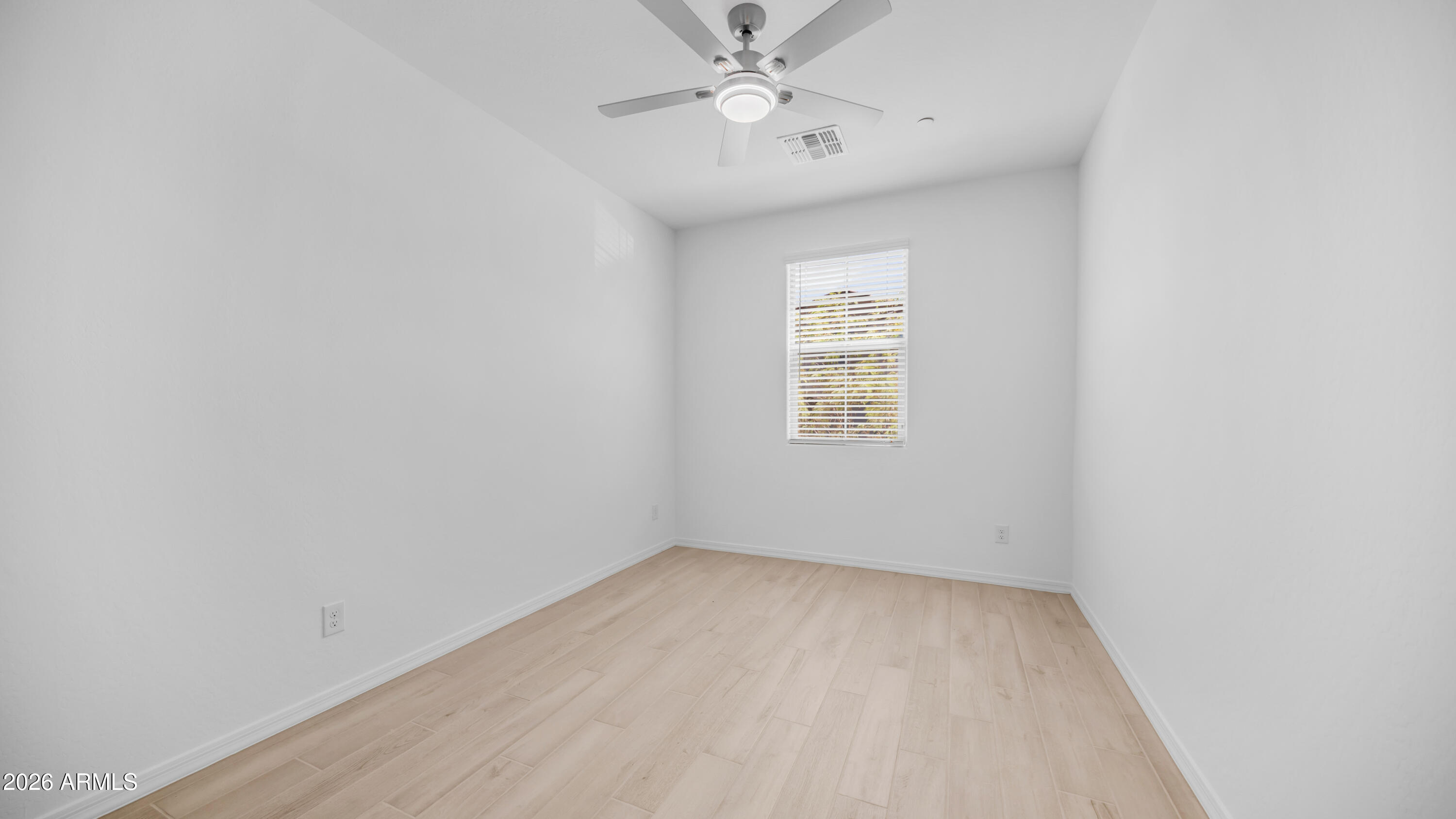 13362 West Eagle Feather Road Peoria, AZ 85383 - Photo 17 of 44 an empty room with a window and ceiling fan