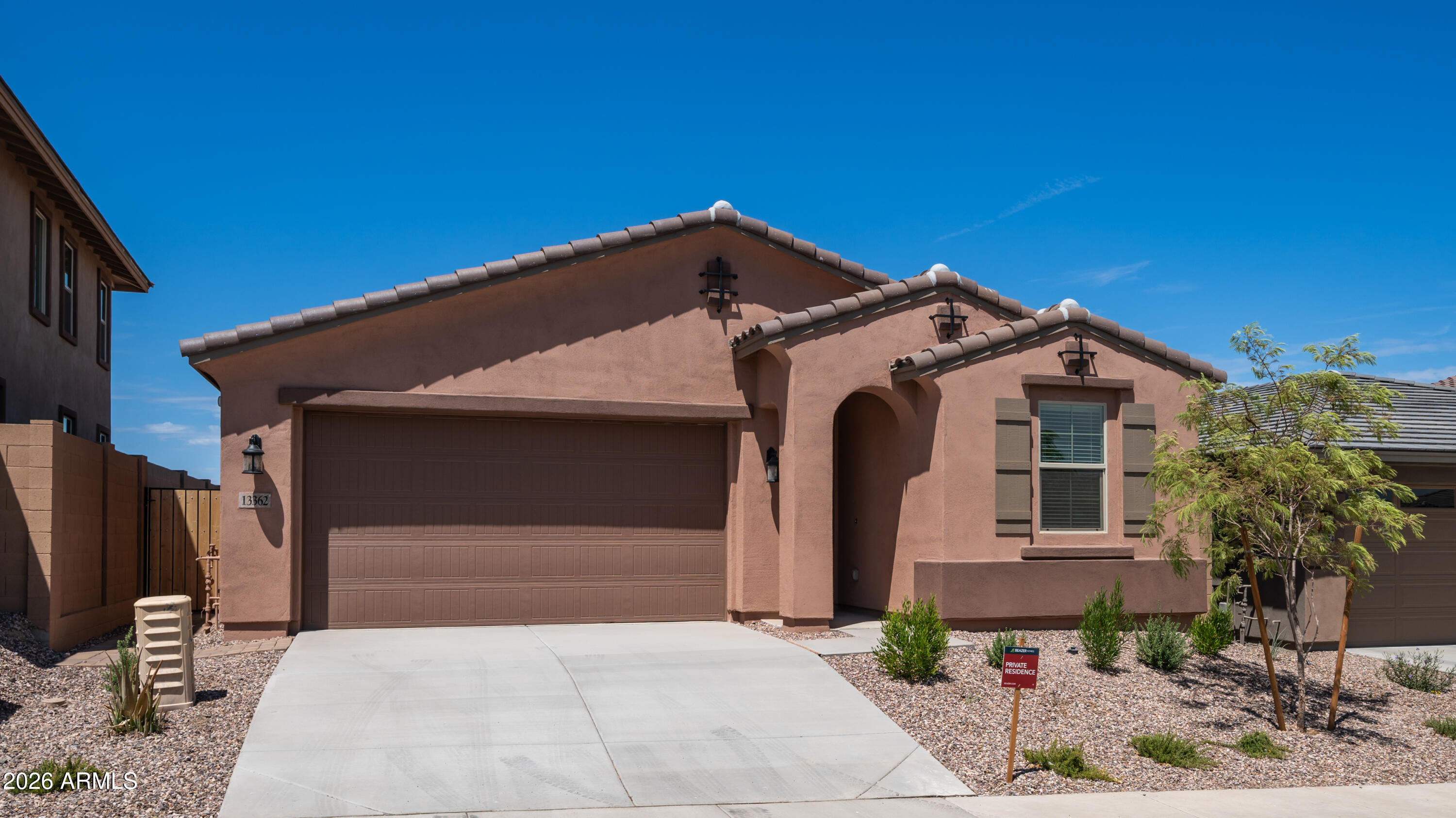 13362 West Eagle Feather Road Peoria, AZ 85383 - Photo 2 of 44 a front view of a house with a garage