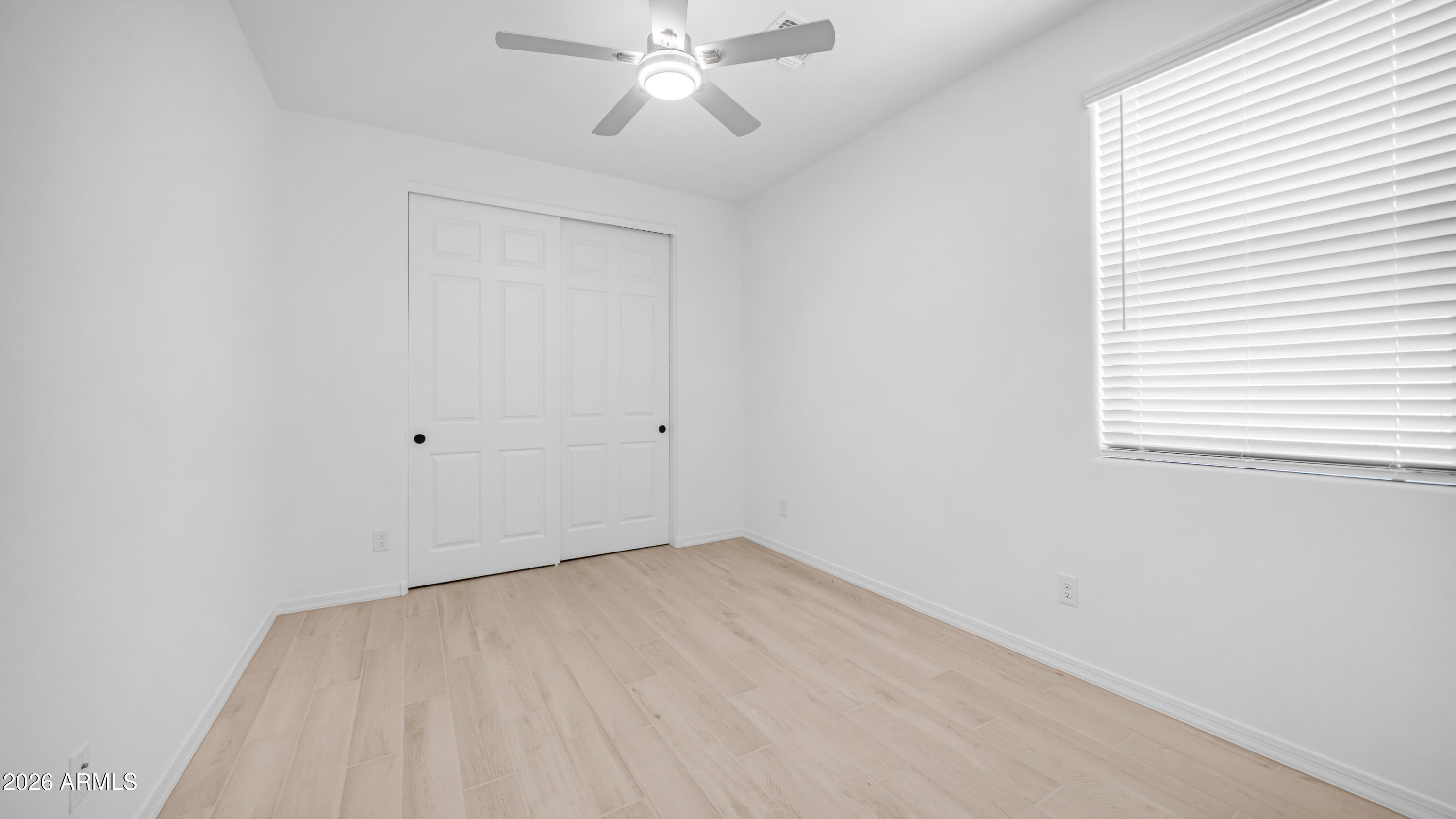 13362 West Eagle Feather Road Peoria, AZ 85383 - Photo 23 of 44 an empty room with a window and a fan
