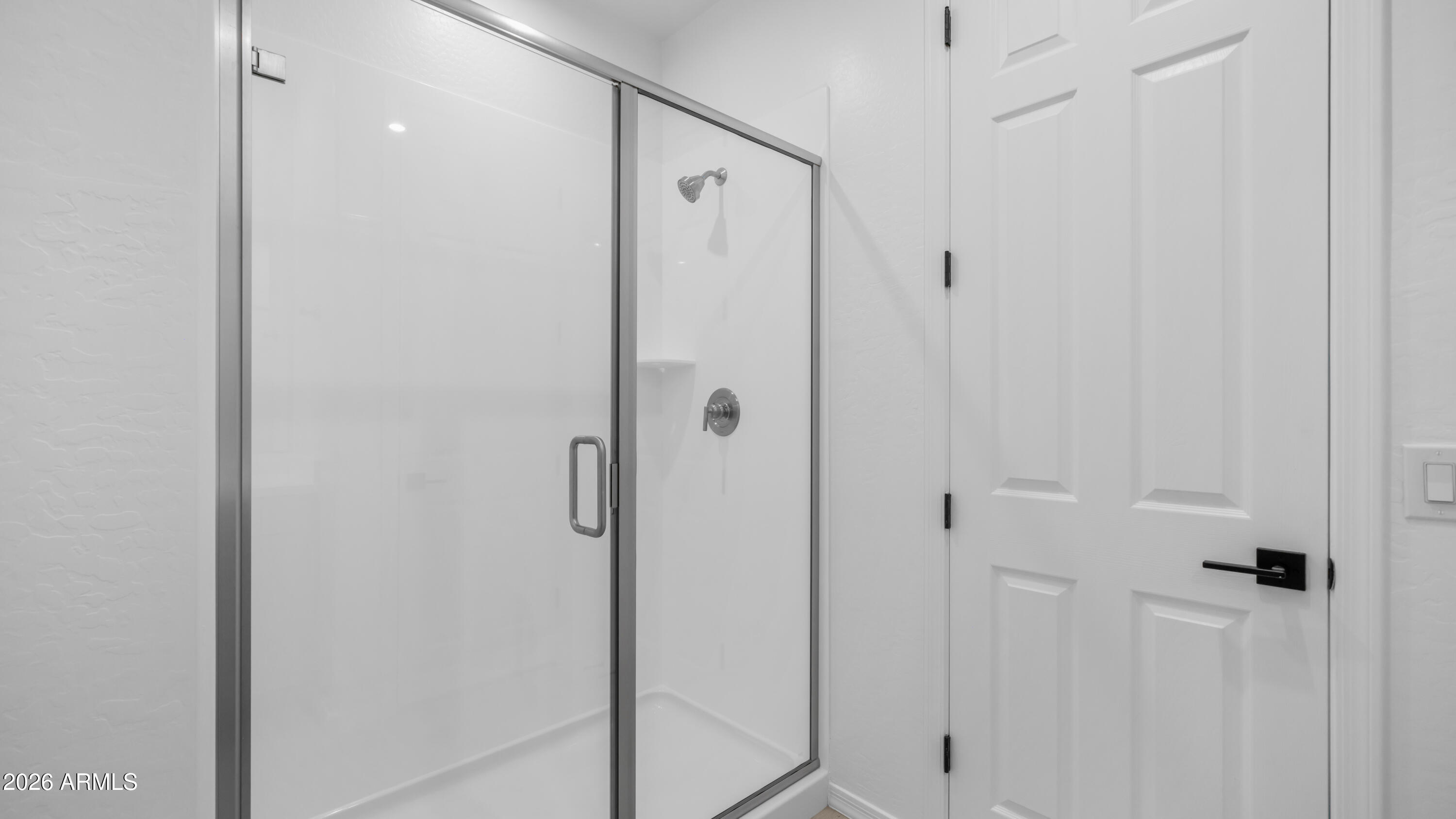 13362 West Eagle Feather Road Peoria, AZ 85383 - Photo 25 of 44 a bathroom with a shower and a glass door