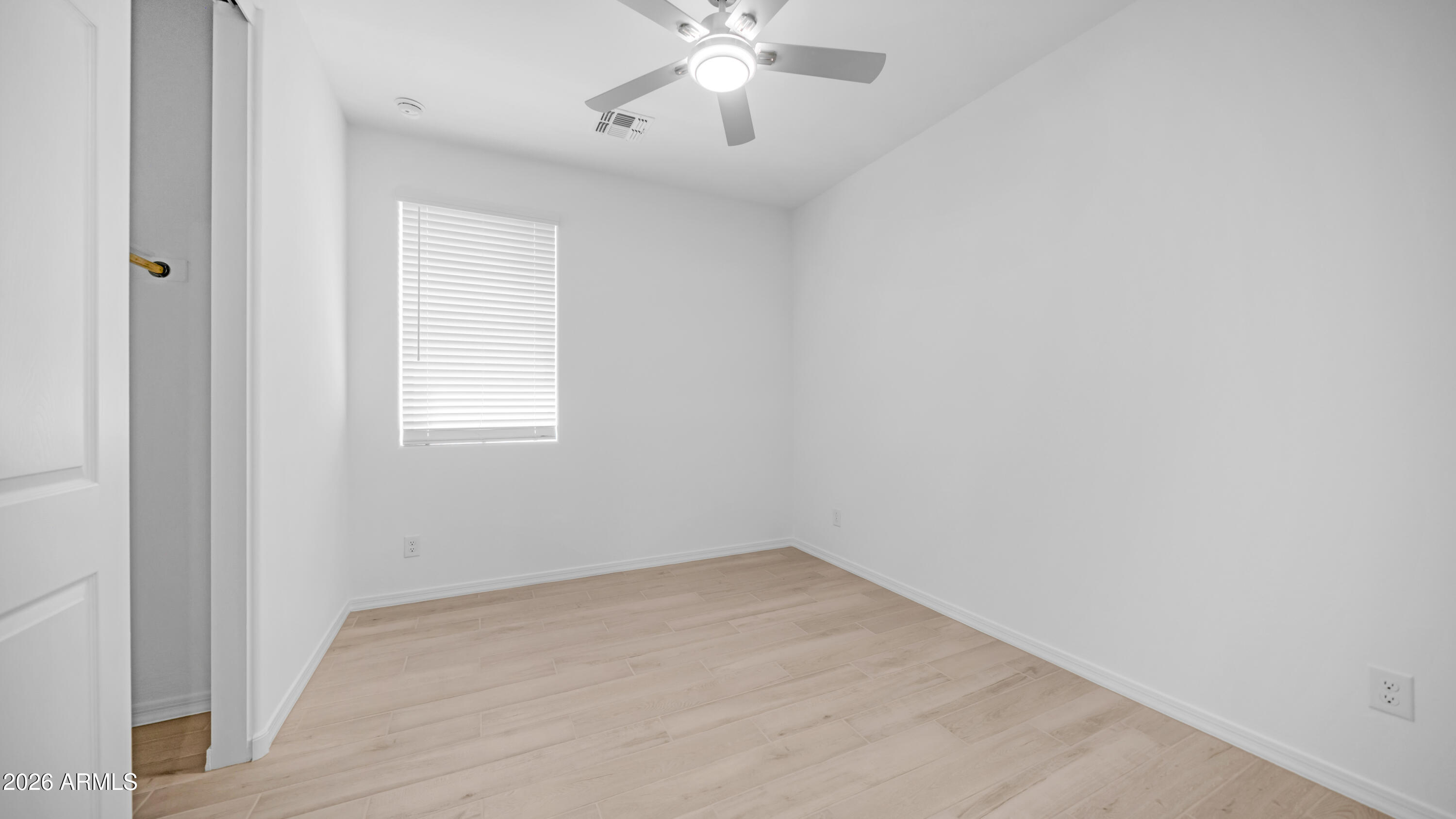 13362 West Eagle Feather Road Peoria, AZ 85383 - Photo 27 of 44 an empty room with a window and a ceiling fan