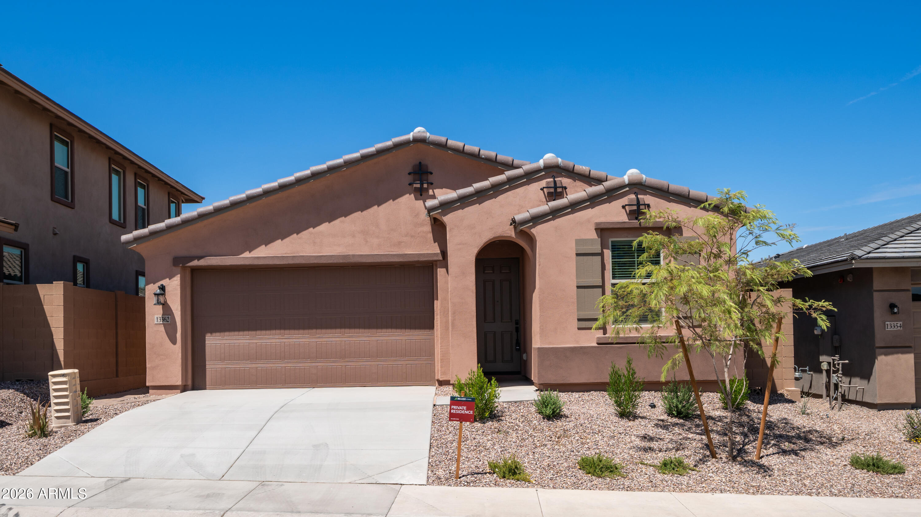 13362 West Eagle Feather Road Peoria, AZ 85383 - Photo 3 of 44 a front view of a house with garden