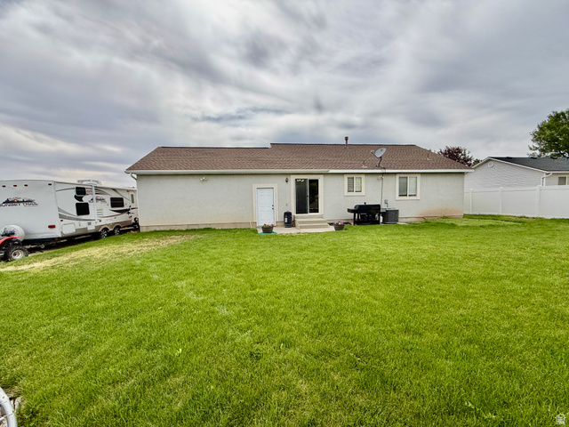 1353 360 West Payson, UT 84651 - Photo 14 of 16 Expansive green lawn with a stucco exterior home featuring a brown shingle roof