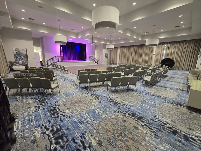a living room with furniture a large window and a table