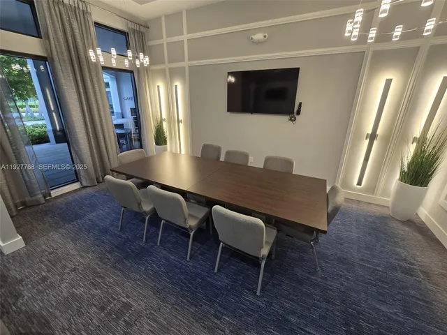 a kitchen with stainless steel appliances a sink a stove a chimney a refrigerator and a counter top space