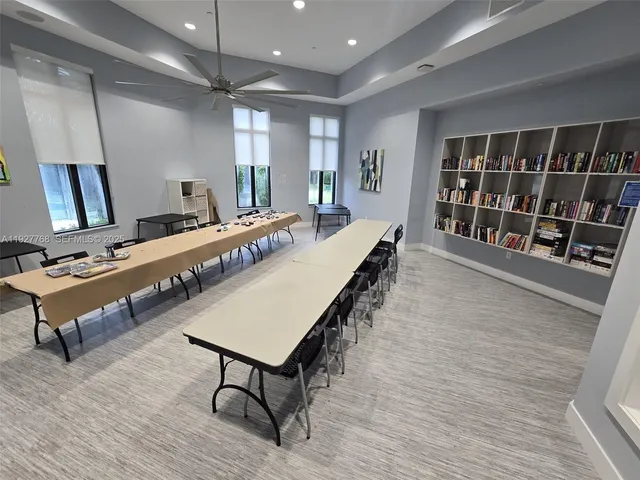 a view of a dining room with furniture and a potted plant