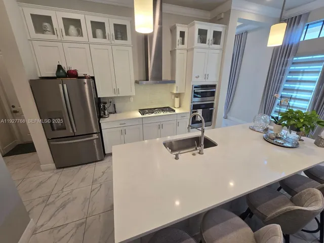 a bathroom with a sink double vanity granite tub shower and a mirror