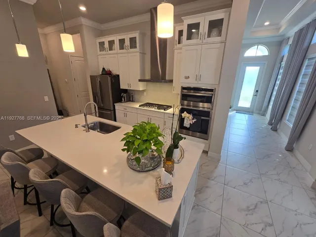 a white toilet sitting next to a white cabinet