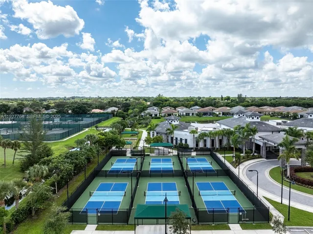a bedroom with a bed tv and a window