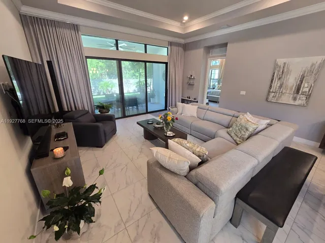 a living room with wooden floor furniture and a table