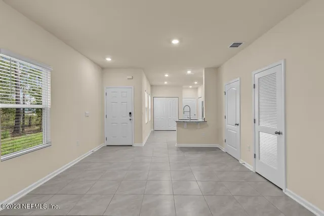 a view of a big room with windows and chandelier
