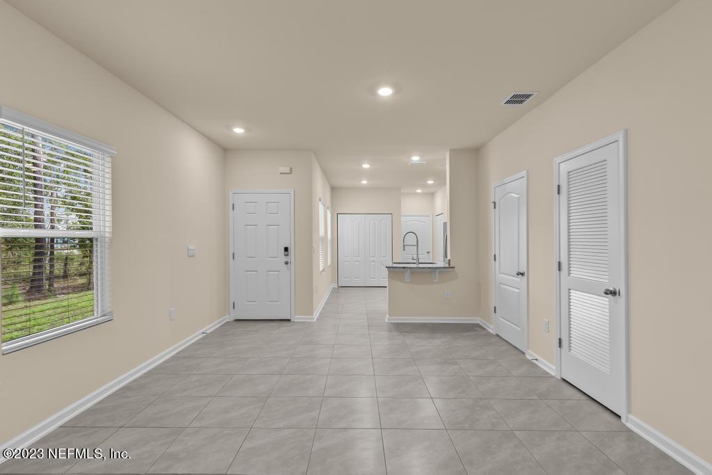 279 Talulla Trail St. Augustine, FL 32095 - Photo 17 of 52 a view of a big room with windows and chandelier