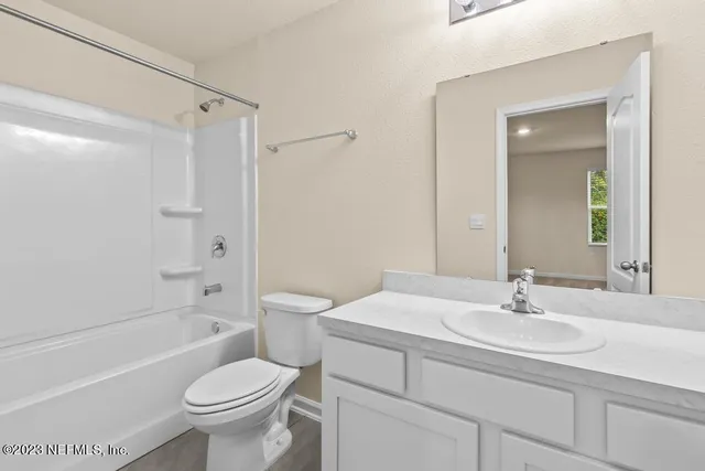 a bathroom with a toilet sink and a mirror