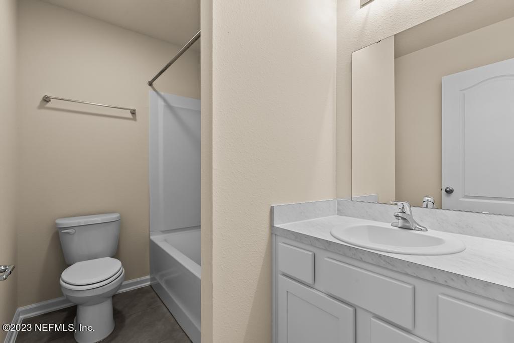 279 Talulla Trail St. Augustine, FL 32095 - Photo 29 of 52 a bathroom with a sink a toilet and shower