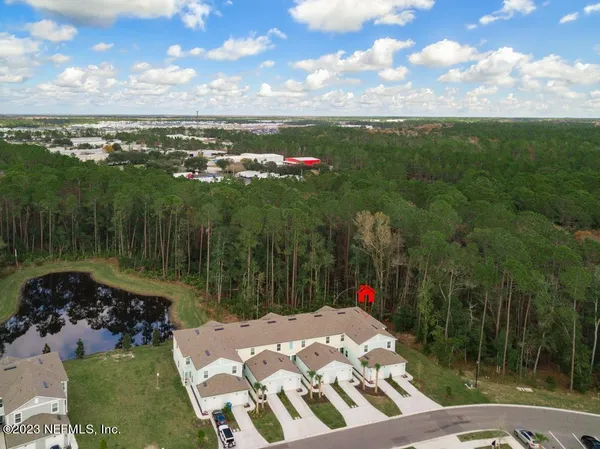 an aerial view of a house with outdoor space and pool