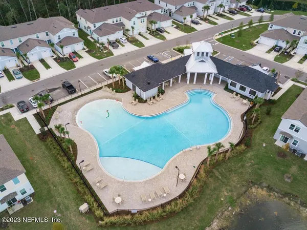 a view of a yard with a house in the background