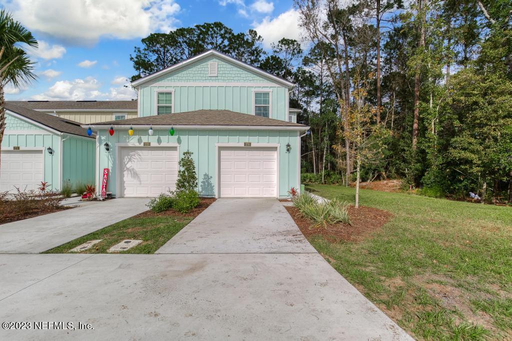 279 Talulla Trail St. Augustine, FL 32095 - Photo 46 of 52 a front view of a house with a yard and garage