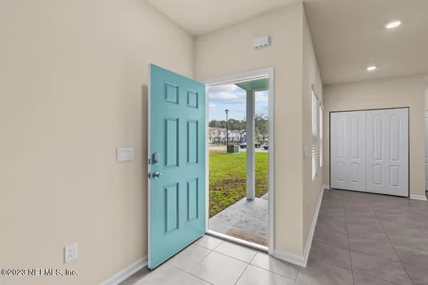 a view of a hallway with a livingroom and entryway