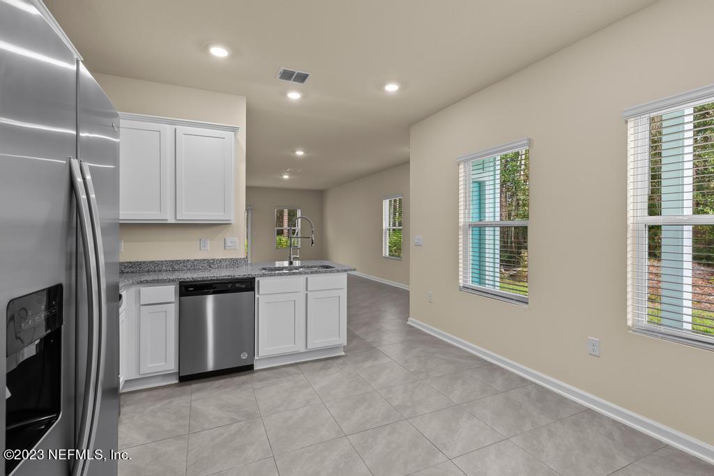 279 Talulla Trail St. Augustine, FL 32095 - Photo 10 of 52 a kitchen with granite countertop white cabinets and stainless steel appliances