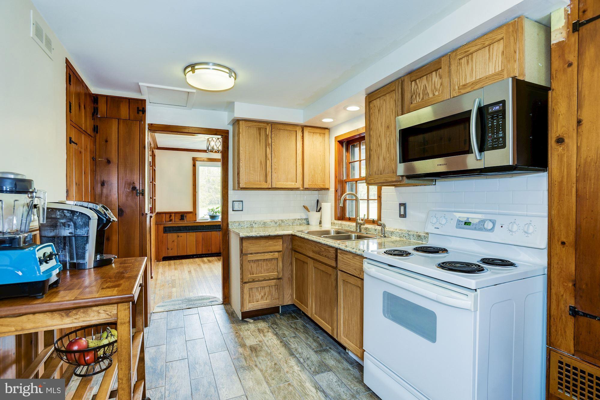 4404 Church Road Mount Laurel, NJ 08054 - Photo 13 of 22 a kitchen with stainless steel appliances a stove microwave and sink