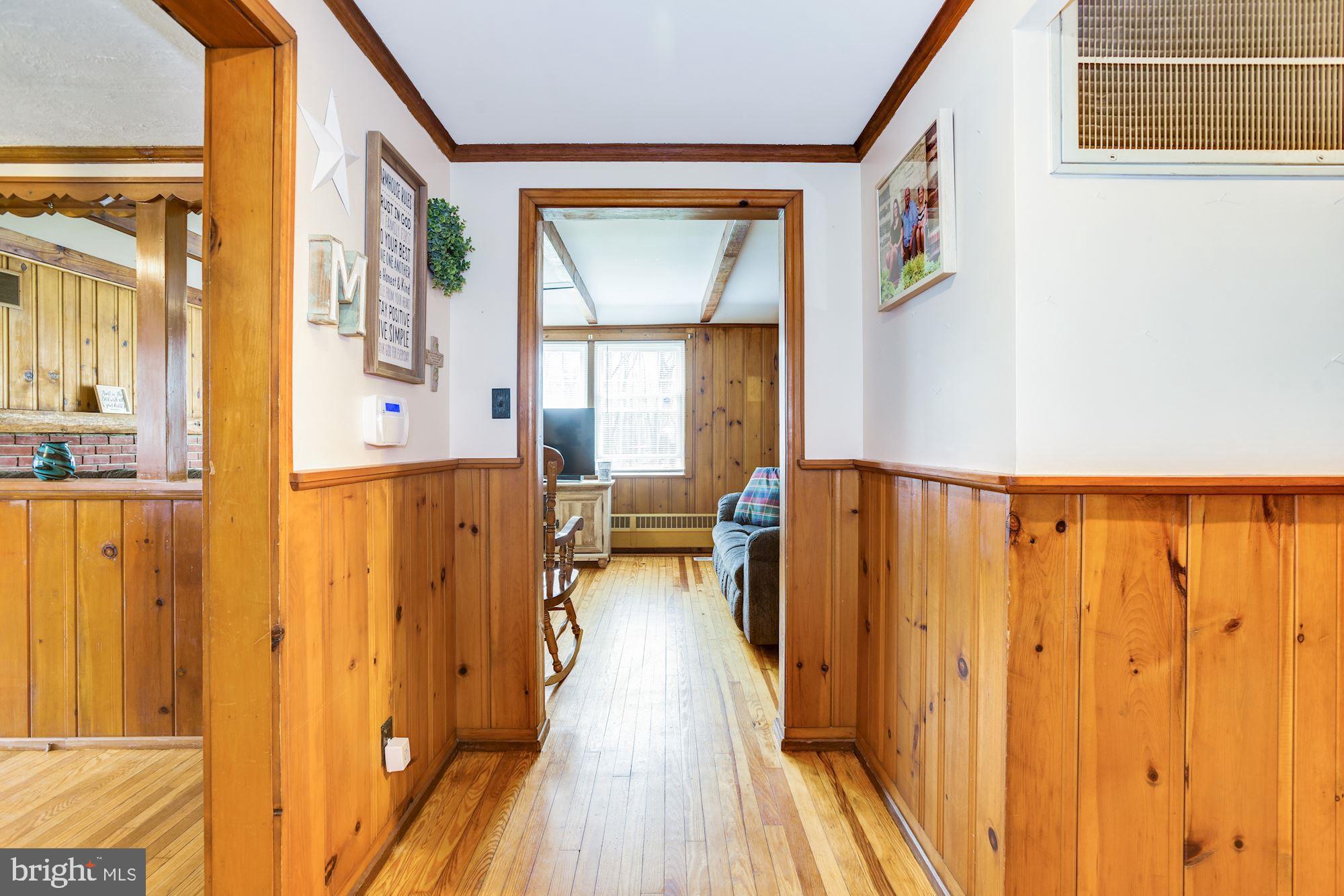 4404 Church Road Mount Laurel, NJ 08054 - Photo 3 of 22 a view of a hallway with wooden floor and staircase
