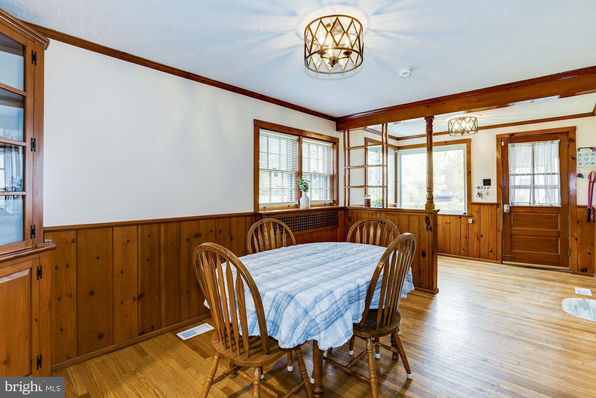 4404 Church Road Mount Laurel, NJ 08054 - Photo 8 of 22 a view of a dining room with furniture a chandelier and wooden floor