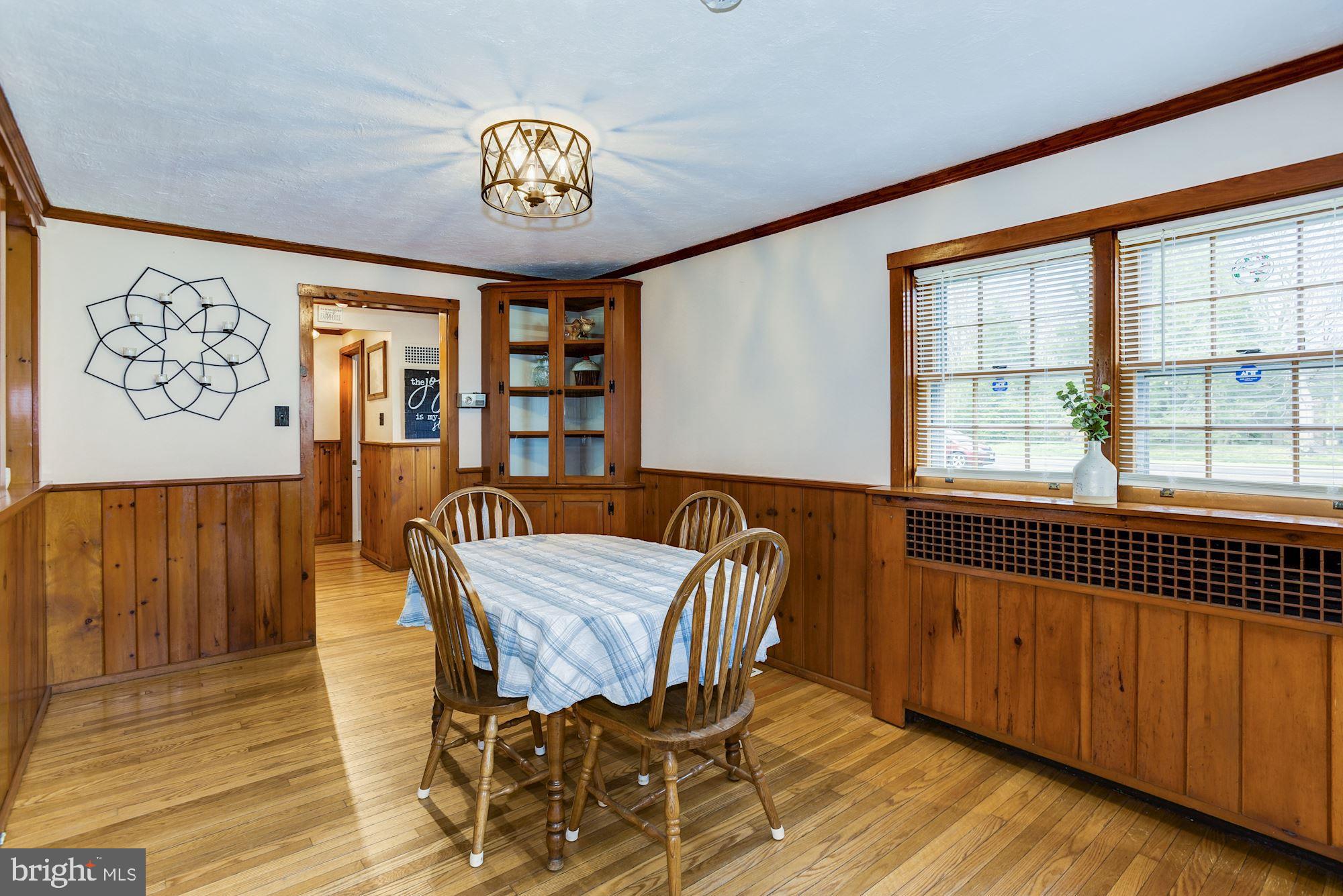 4404 Church Road Mount Laurel, NJ 08054 - Photo 9 of 22 a view of a dining room with furniture a chandelier and wooden floor