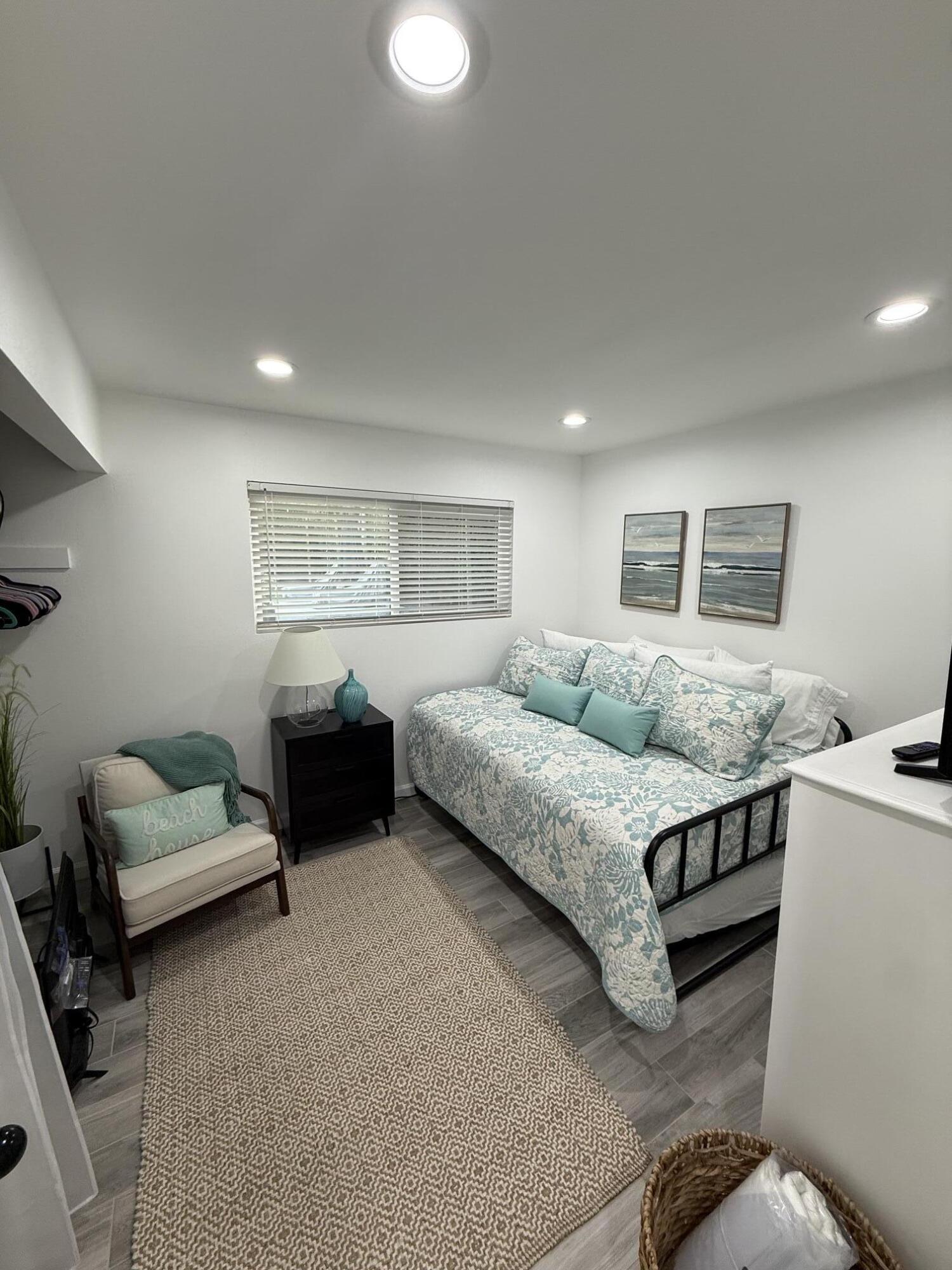 37081 Palmdale Road Rancho Mirage, CA 92270 - Photo 27 of 46 a spacious bedroom with a bed a couch and a dresser
