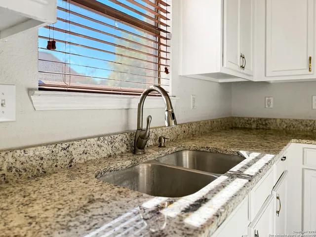 a kitchen with stainless steel appliances granite countertop a stove and a sink