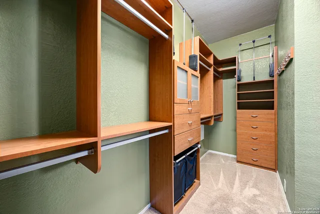 a view of a patio with table and chairs with wooden floor and fence and a floor to ceiling window