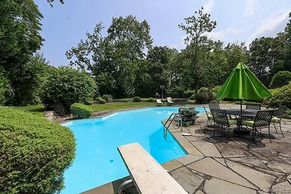 an outdoor sitting area with furniture and umbrella