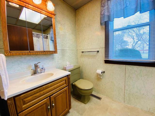 1700 West Goodfarm Road Dwight, IL 60420 - Photo 8 of 25 a bathroom with a sink a toilet and mirror