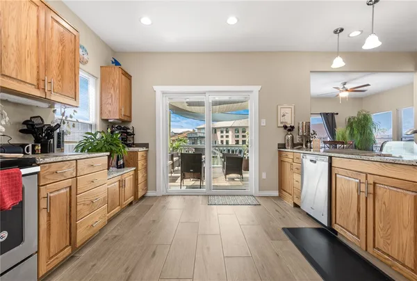 a kitchen with stainless steel appliances granite countertop a stove a sink and a refrigerator