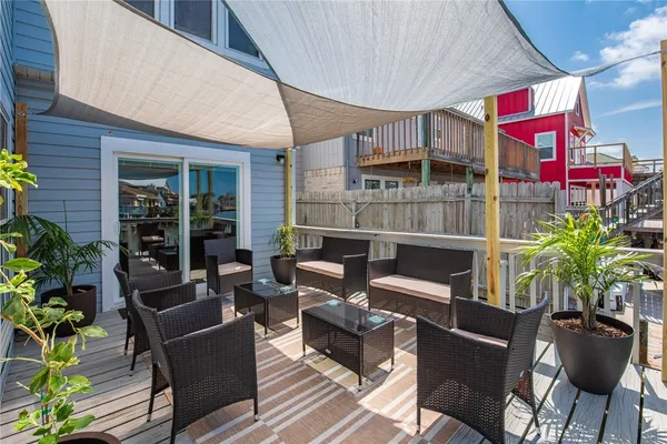 a view of a balcony with chairs and wooden floor