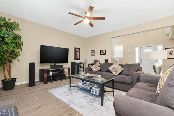 a living room with lots of furniture and a large window