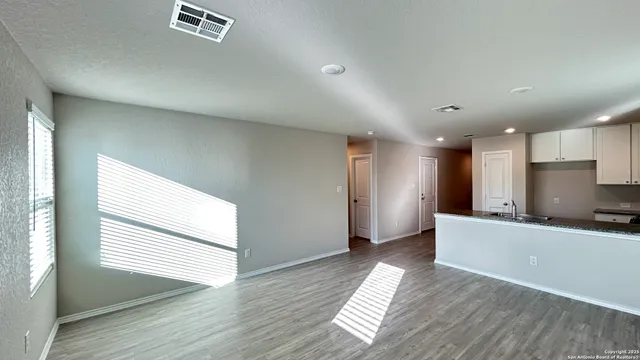 a view of a kitchen with a sink and a window