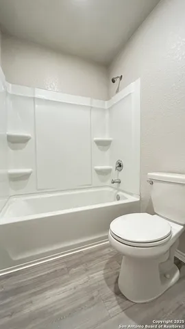 a bathroom with a toilet and a tub