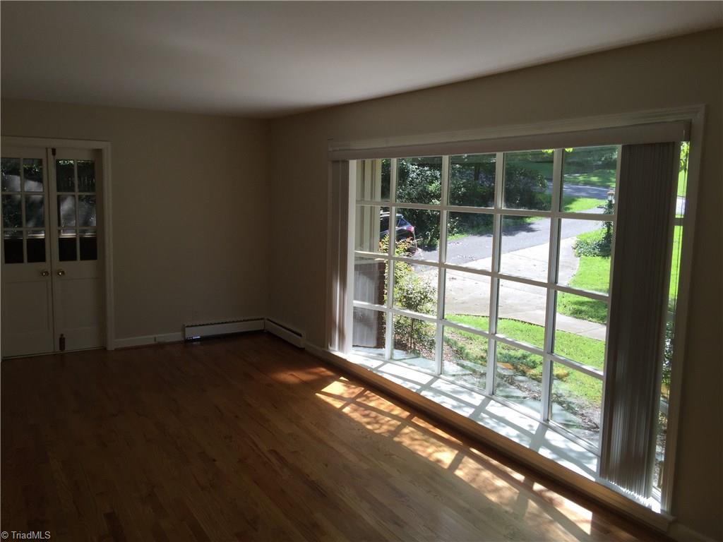 350 Robin Road Mount Airy, NC 27030 - Photo 3 of 23 Large living room with bow window, hardwood floors and entrance to screened in porch