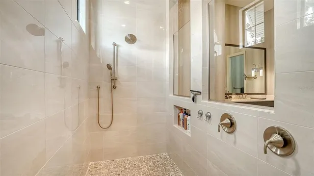 an aerial view of a house with a garden and lake view