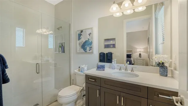 an aerial view of a swimming pool with a yard and lake view