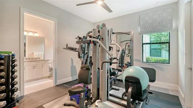 a view of a kitchen with stainless steel appliances granite countertop a sink dishwasher a flat tv screen and a dining table with chairs